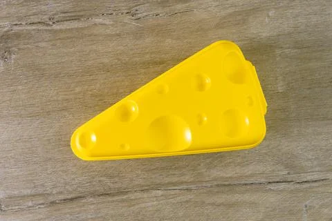 Eco-friendly yellow special container for storing cheese, on a wooden table,  Stock Photos