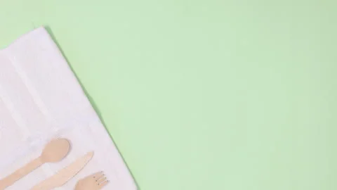 Eco friendly zero waste utensil appear on white cloth on left side Stop motion Stock Footage 154381843