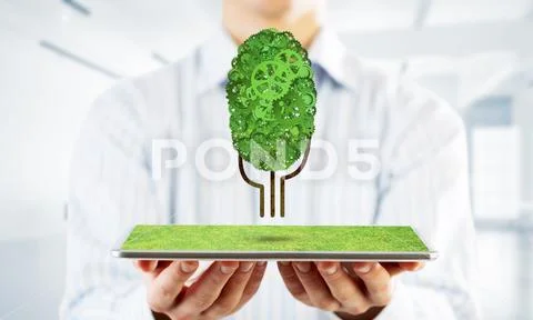 Eco green environment concept presented by tree as working mechanism or engine Stock Photos