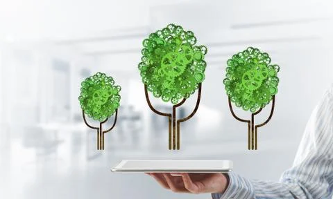 Eco green environment concept presented by tree as working mechanism or engine Stock Photos