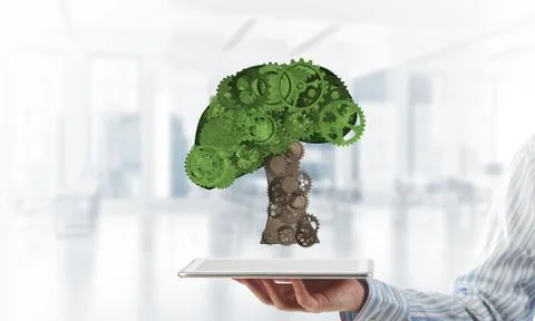 Eco green environment concept presented by tree as working mechanism or engine 写真素材