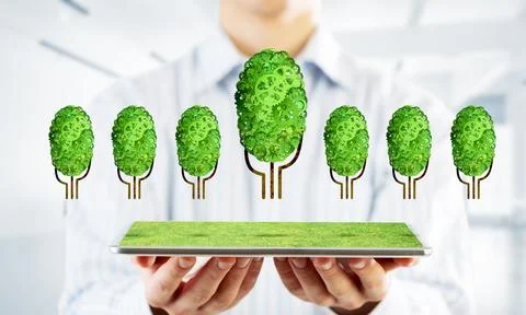Eco green environment concept presented by tree as working mechanism or engine 写真素材