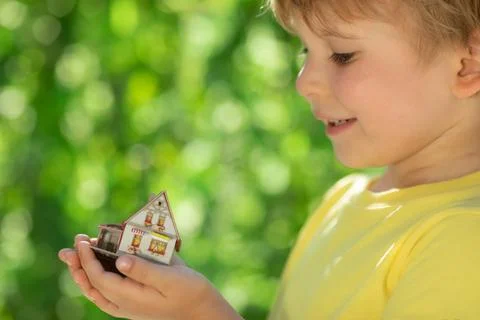 Eco house in children`s hands Stock Photos