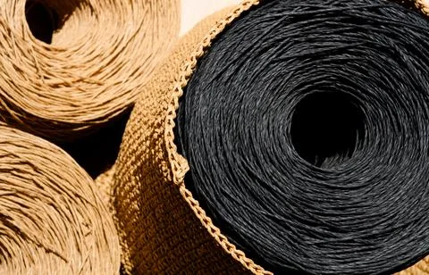 ECO material. Close-up of raffia balls on a wooden board. Stock Photos