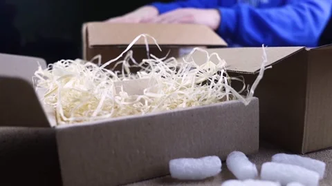 Eco package of parcels and biodegradable filler. Box is filled with a filler tha Stock Footage 233066078