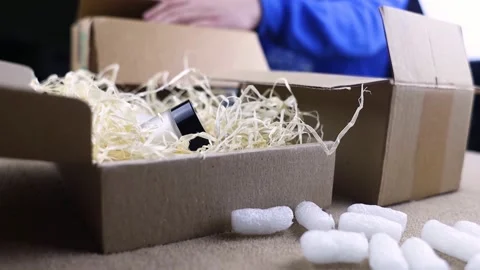 Eco package of parcels and biodegradable filler. Box is filled with a filler tha Stock Footage 233066096