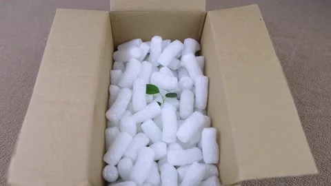 Eco package of parcels and biodegradable filler. Box is filled with a filler tha Stock Footage 233066105