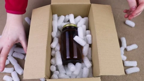 Eco package of parcels and biodegradable filler. Box is filled with a filler tha Stock Footage 233066151