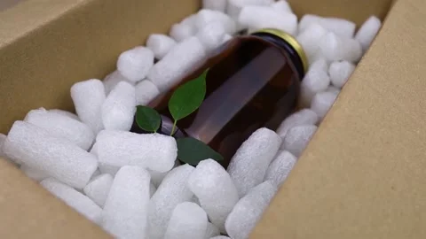 Eco package of parcels and biodegradable filler. Box is filled with a filler tha Stock Footage 233066239