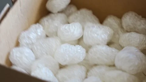 Eco packaging of parcels and white biodegradable filler. Box is filled with a Stockbeeldmateriaal 277151084