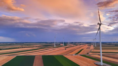 Eco power turbine under dramatic purple sunset sky. High aerial perspective of Stock Footage 339017256