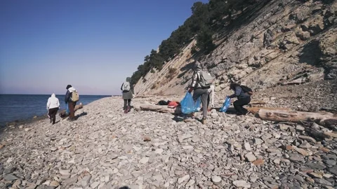 Eco volunteers.Teamwork cleaning plastic on the beach Stock Footage 185090699