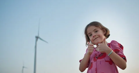 Eco-Warrior in the Making: Powerful Visuals of a Young Girl Amid Wind Turbines Stock-Footage 244792624
