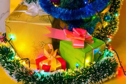 Ecologic Christmas tree made from gift boxes and rustic Christmas decorations on Stock Photos