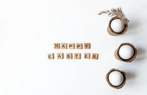Ecological concept with Easter white eggs with happy Easter inscription. Stock Photos