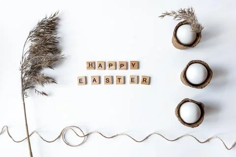 Ecological concept with Easter white eggs with pampas grass and happy Easter  Stock Photos