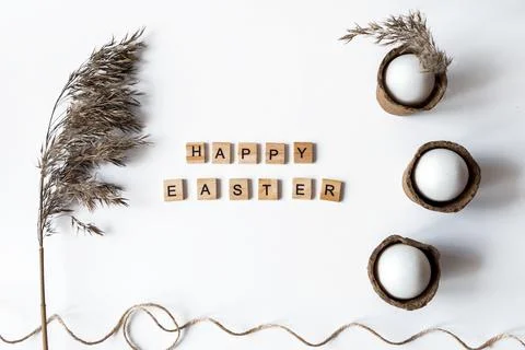 Ecological concept with Easter white eggs with pampas grass and happy Easter  Stock Photos