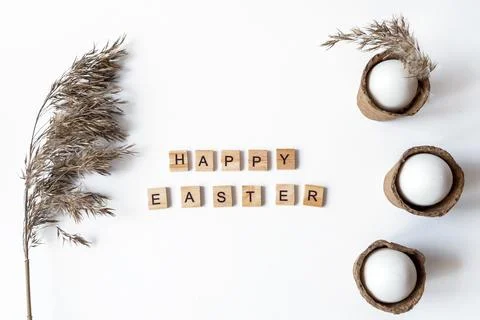 Ecological concept with Easter white eggs with pampas grass and happy Easter  Stock Photos