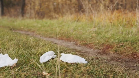 Ecological concept of garbage collection. A responsible young man picks up Stock Footage 120872658