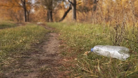 Ecological concept of garbage collection. Responsible young man raises a plastic Stock Footage 120872827