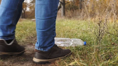 Ecological concept of garbage collection. Responsible young man raises a plastic 库存影片 120872883