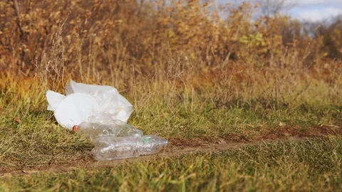 Ecological concept of garbage collection. A responsible young man picks up a Stock Footage 120873256