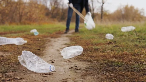 Ecological concept stop plastic. Close-up, a responsible male volunteer in jeans Stock Footage 120872261