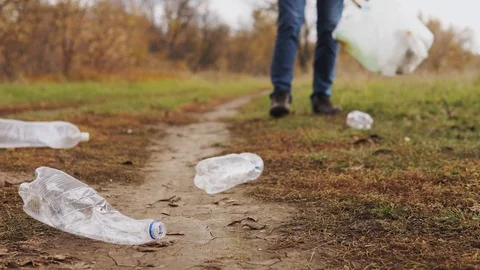 Ecological concept stop plastic. Close-up, a responsible male volunteer in jeans Stock Footage 120872331