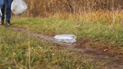 Ecological concept, stop plastic. Close-up, a conscious male volunteer picks up Stock Footage 120872395