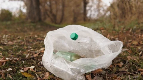 Ecological concept stop plastic. White bag with plastic bottles on the grass Stock Footage 120871965