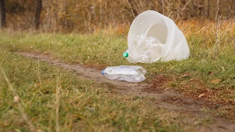 Ecological concept stop plastic. White bag with plastic bottles on the grass Stock Footage 120872308