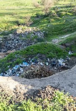 Ecological disaster. Garbage among the hills. Stock Photos