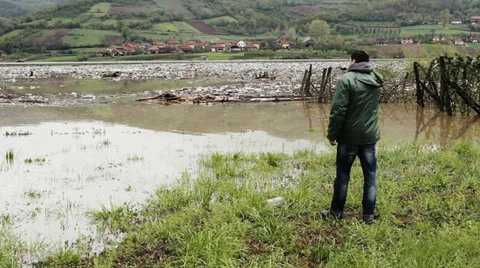 Ecological disaster, large amount of trash in lake, man taking plastic bottle. Stock Footage 37788012