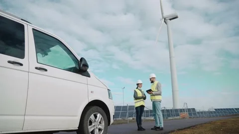 Ecological engineers use digital tablet and talk at the solar panel field Stock-Footage 171968787