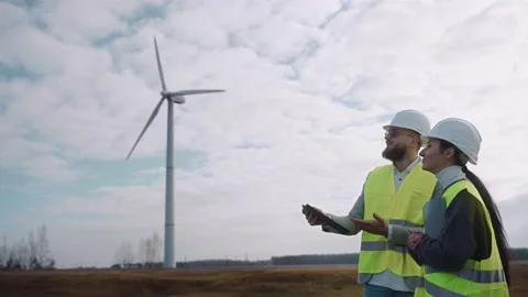 Ecological engineers work using digital tablet at the windmill field Vídeo Stock 171968855