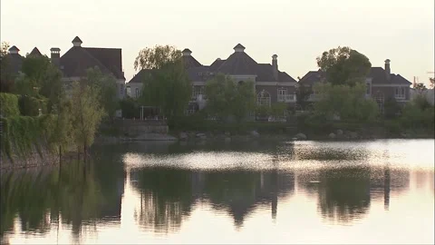 Ecological environment of lakeside villa during daytime Stock Footage 252482030