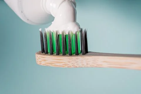 Ecological toothbrush with biodegradable bristles with toothpaste on top. Stock Photos