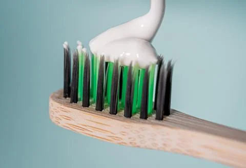 Ecological toothbrush with biodegradable bristles with toothpaste on top. Stock Photos