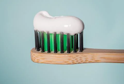 Ecological toothbrush with biodegradable bristles with toothpaste on top. Stock Photos