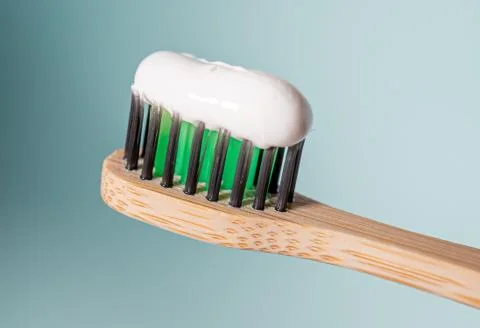 Ecological toothbrush with biodegradable bristles with toothpaste on top. Stock Photos