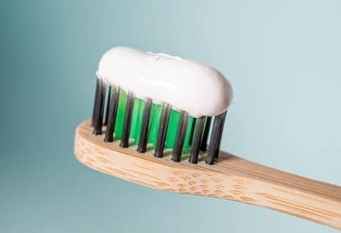 Ecological toothbrush with biodegradable bristles with toothpaste on top. Stock Photos