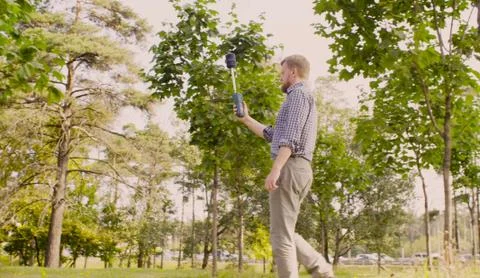 Ecologist measuring the level of electromagnetic radiation near highway Stock Photos