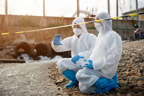 Ecologist sampling water from the river with test tube Stock Photos
