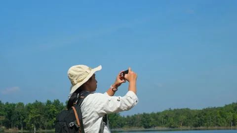 Ecologist uses mobile phone to take pictures of the reservoir for data analysis. Stock Footage 226475272