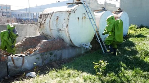 Ecologists in protective equipment exploring the receptacle.Danger, risk Video stock 99361382