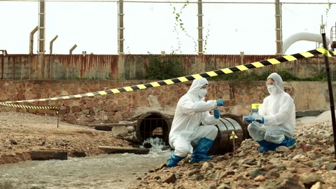 Ecologists sample water contaminated with dangerous, waterhazard toxins in tube Stock Footage 199231480