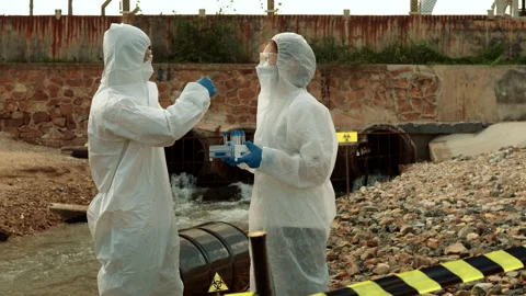 Ecologists sample water contaminated with dangerous, waterhazard toxins in tube Stock Footage 199231482