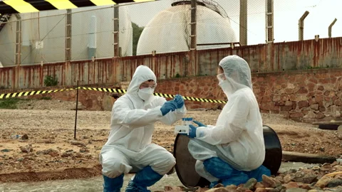 Ecologists sample water contaminated with dangerous, waterhazard toxins in tube Stock Footage 199232385