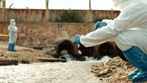 Ecologists sample water contaminated with dangerous, waterhazard toxins in tube Stock Footage 199233309