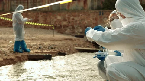 Ecologists sample water contaminated with dangerous, waterhazard toxins in tube Stock Footage 199233850